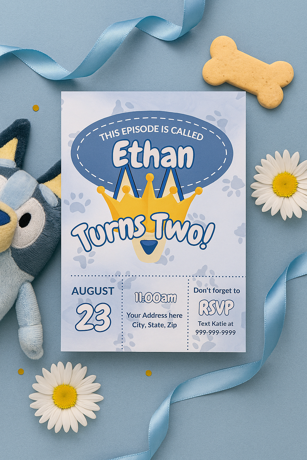 Flat lay of Bluey-inspired second birthday invitation for boys featuring blue tones, a crown, subtle dog ears, paw prints, and playful ribbon and daisy accents. Includes editable text and fun toddler-friendly design.
